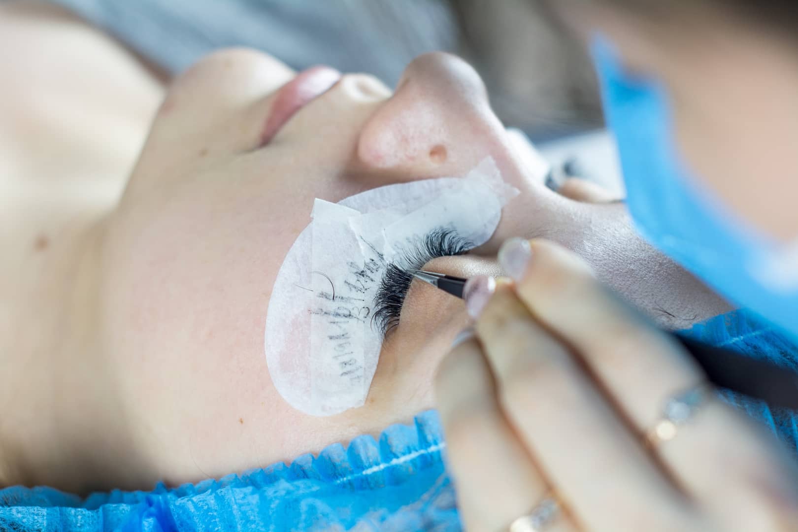 Starting a lash business , lady getting her lashes installed.