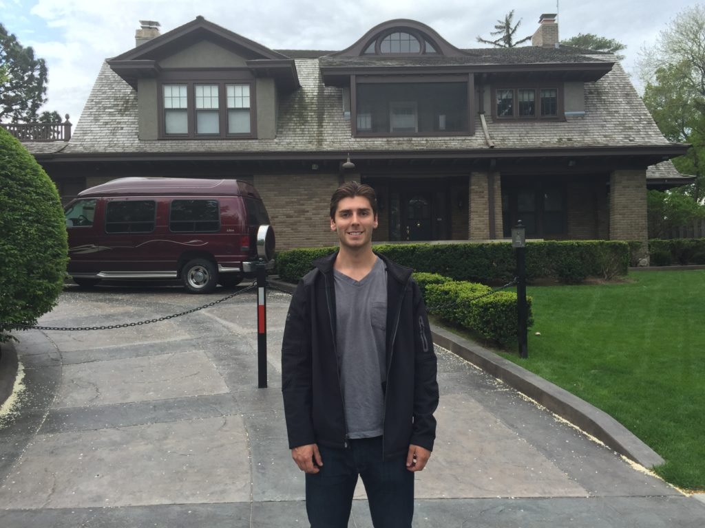 a guy standing in front of a house