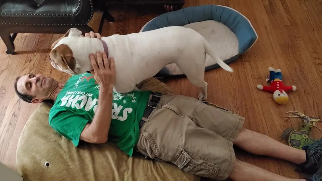 Snuggling with a dog on the floor