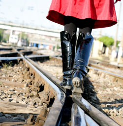 Girl walking on railroad track