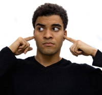 Man with fingers in ears